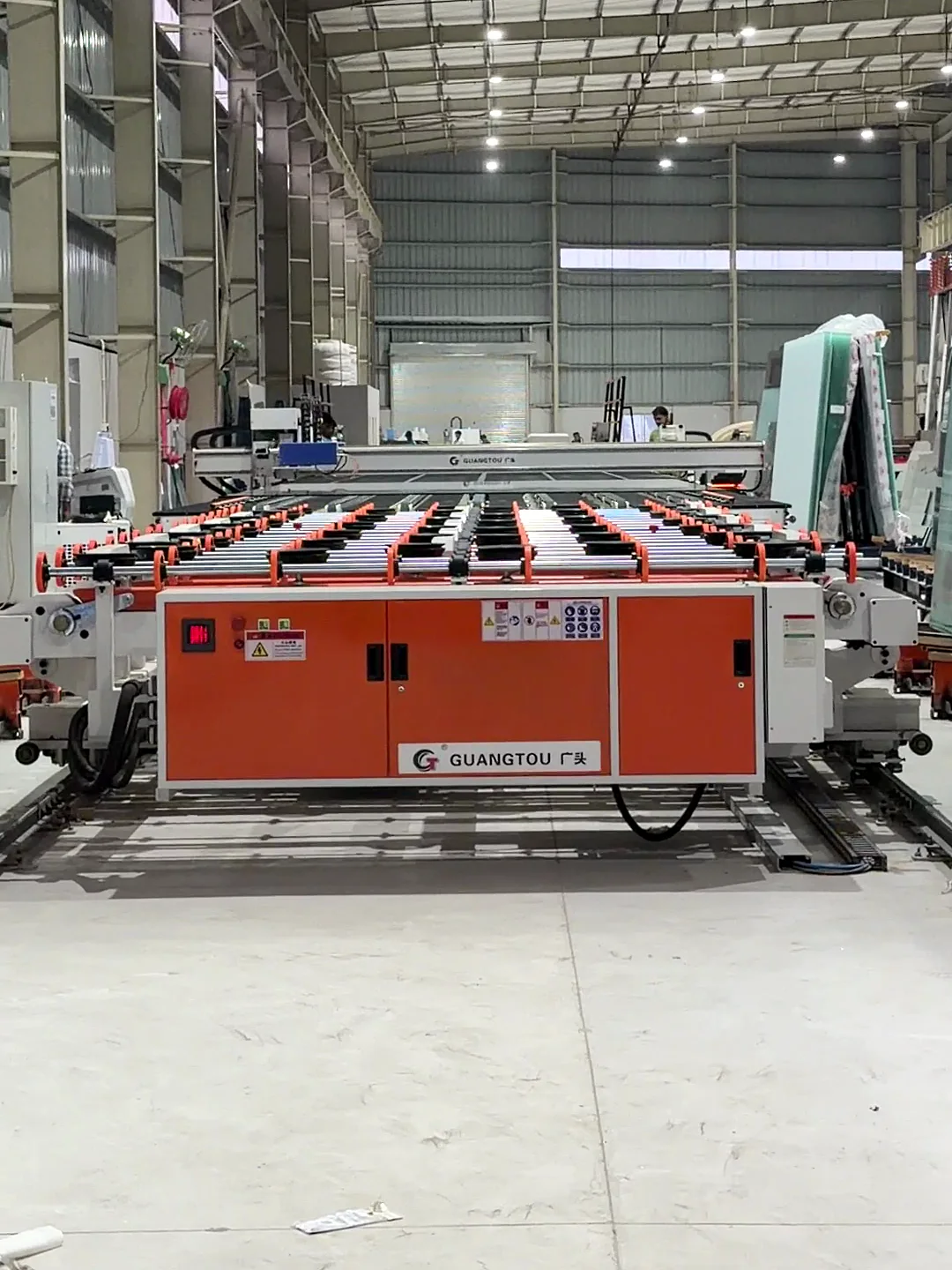 The cutting line's table between racks of jumbo sheets, ARG's new machinery